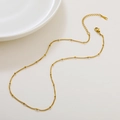 Elegant gold-plated bead chain necklace with lobster clasp and extension on white surface - 04 Curb Bead Chain
