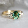 Elegant emerald cut green gemstone ring with marquise side stones in gold plating - US 6 / Gold