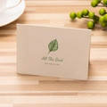 Cream greeting card with green leaf illustration and All The Best text on wooden table - All The Best / Single Card