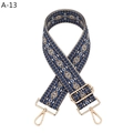 Detail of blue and brown geometric jacquard purse strap with gold lobster clasps - Blue