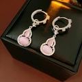 Macro view of pink opal gourd earrings with zircons on a luxury black jewelry box - Hoop Earrings-Silver