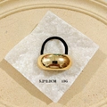 Gothic punk hair clip with a polished gold oval metal piece on a black elastic band - 1066-5 Oval Smooth