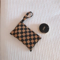 Detail of checkered corduroy pouch showing brown and black plaid texture and hand strap - Black and Yellow Checkered