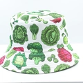 Detail of vibrant vegetable print featuring broccoli and cabbage on a white bucket hat - White Vegetable Print