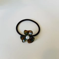Elegant floral hair tie featuring a dark tortoiseshell resin petal and white pearl detail - Blue Tortoise