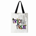 White Halloween trick or treat canvas tote bag with black handles and festive graphic - Trick or Treat Text