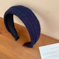 Detailed close-up showing the navy blue cable-knit fabric texture and stitch of the headband - Blue
