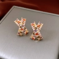 Macro view of gold-plated X-shape earrings featuring multi-colored zircon stones - 18K Gold Plated Rainbow Zirconia X-Shape (WE4641)
