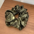Glossy metallic bronze scrunchie with pleated texture on a wooden background - Large / Dark Green