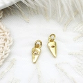 Detailed macro view of gold cone pendant with evil eye motif and clear crystal stone - Triangle Eye