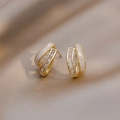 Macro detail of double-layered C-shape earrings with baguette zircons and white shell - White Shell/Baguette Zircon / Gold