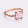 Macro view of rose gold ring featuring a rectangular pink gemstone and white accent stones - US 7 / Rose Gold Color / Light Pink Zirconia
