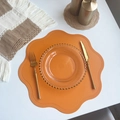 Orange flower-shaped PU leather placemat with embossed dot texture on white desk - Flower / Orange