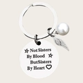 Silver sister keychain with heart quote, pearl and wing charm on beige background - Five-pointed Star