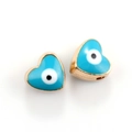 Close-up of heart-shaped evil eye jewelry connectors in sky blue and gold plating - 10pcs Blue Evil Eye Heart Beads