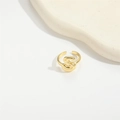 Close-up of golden adjustable ring featuring a 3D letter S on a ceramic plate - Gold Letter S