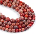Macro detail of red natural stone round beads with polished marble texture for jewelry - Red Imperial Turquoise