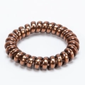 Metallic brown spiral phone cord hair tie with a glossy finish for elegant styling - Brown