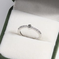 Macro shot of silver letter S ring with diamond accents in a green velvet jewelry box - Platinum S