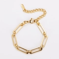 Detailed macro view of golden stainless steel chain link bracelet with lobster clasp - Gold