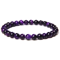 Macro detail of polished purple tiger eye stone bracelet beads with chatoyant cat-eye effect - 6mm Purple Tiger Eye