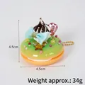 Porte-clés macaron vert et orange avec crème au chocolat et petit nœud bleu élégant - Décoration beignet nœud (avec chaîne à billes dorée) / 4.50cm / Verdoyant