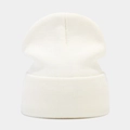 Detailed view of the fine knit texture and folded cuff on a white winter beanie hat - Milky White