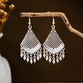 Detailed close-up of ethnic silver leaf tassel earrings on a natural wooden stand - Silver Rhombus Grid Tassel Style (E2873-17)