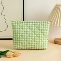 Detailed close-up of green checkered quilted cosmetic bag with metal zipper and soft fabric - 27x6.5x17.5cm / Green Plaid Cotton