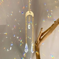 Golden moon sun catcher with transparent crystal prism casting rainbow reflections - B9 Style