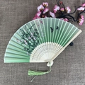 Traditional silk folding fan with green floral pattern and carved bamboo frame - No.48 Green Gradient Floral Butterfly