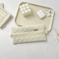 Quilted cream pencil case with diamond patterns and convenient side carrying handle - Beige