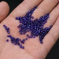 Dark blue transparent glass seed beads held in hand for DIY jewelry making - 3mm / 15g / Dark Blue