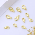 Flat lay of ten polished 18K gold-plated lobster clasps for DIY jewelry making - 12mm / 14K Gold Plated