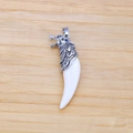 Wolf tooth resin pendant with detailed silver wolf head on light wooden background - Wolf Head Style Pendant