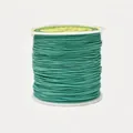 Macro detail of 0.8mm emerald green jade thread spool for manual jewelry braiding - Color 234 Forest Green
