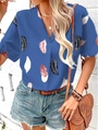 Close-up of lightweight blue summer shirt with vibrant feather print and button detail - Blue