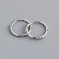 Macro shot of polished S925 sterling silver hoop earrings with a mirror finish - 13mm Inner Diameter (Platinum Color)