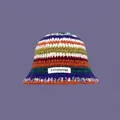 Hand-knitted colorful striped bucket hat with a woven label and vibrant purple background - One Size / Rainbow Hat
