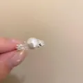Silver-toned textured alloy ring featuring a large white round pearl in a hand-held view - Single Pearl Zircon Ring