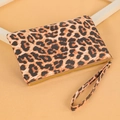 Detail shot of leopard print clutch wallet with golden zipper and wristlet strap - Leopard Print