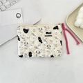 Close-up of quilted floral cosmetic pouch featuring cute cartoon cat and dog patterns - Black Cat & Dog