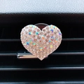 Close-up of heart-shaped rhinestone car vent clip decoration with colorful crystals - White