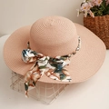 Pink straw sun hat with large brim, floral ribbon bow, and pearl decorative detailing - Pink