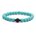Detail of blue turquoise beads bracelet with a black volcanic lava stone and metal spacers - Blue Green Turquoise Volcanic Lava Single Bracelet