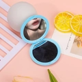 Light blue foldable macaron round mirror on pink background with floral decor - Blue