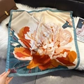Elegant floral silk scarf with large peony print on cream satin displayed on plush mat - Peacock Blue (W-476)