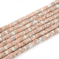 Detailed macro view of pink and white flat disc natural stone beads for DIY jewelry - Pink