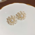 Macro shot of elegant bow flower pearl earrings on a decorative gold-trimmed ceramic plate - Silver Earring Post - White Acrylic Petal Pearl Stud