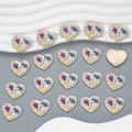 Flat lay of colorful heart enamel pendants with evil eye and floral motifs for DIY jewelry - Style YJ13-05